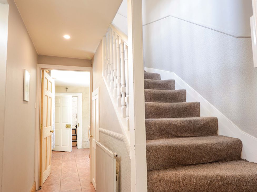 A staircase and hallway with doors and a radiator at 6 Hill Street