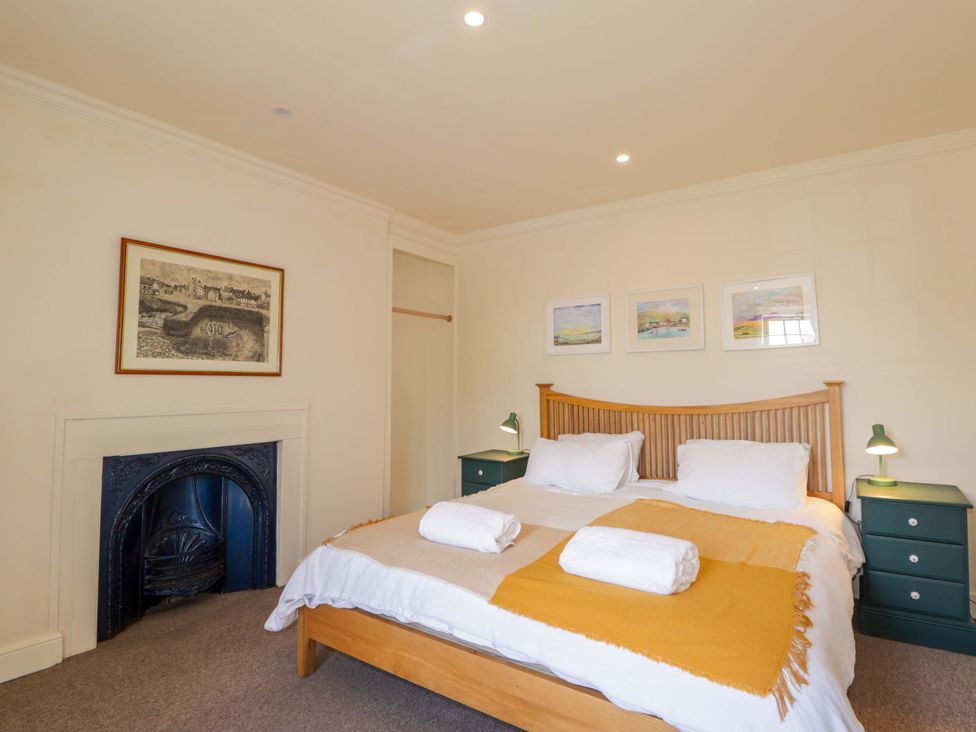 A bedroom with a bed and nightstands at 6 Hill Street