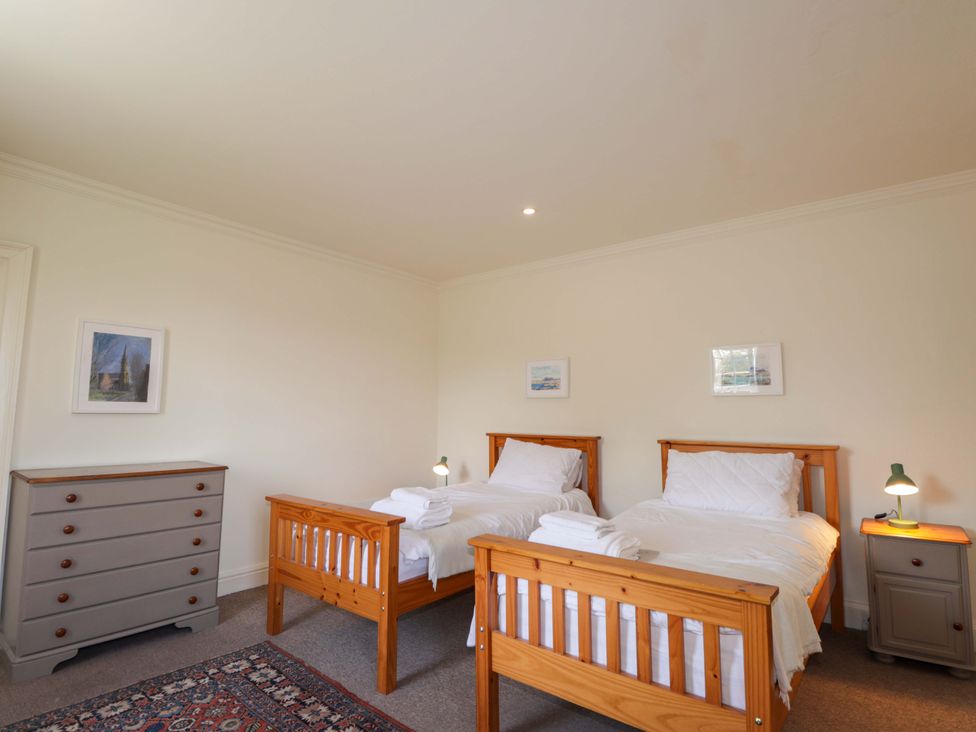 A bedroom with two single beds and a dresser at 6 Hill Street