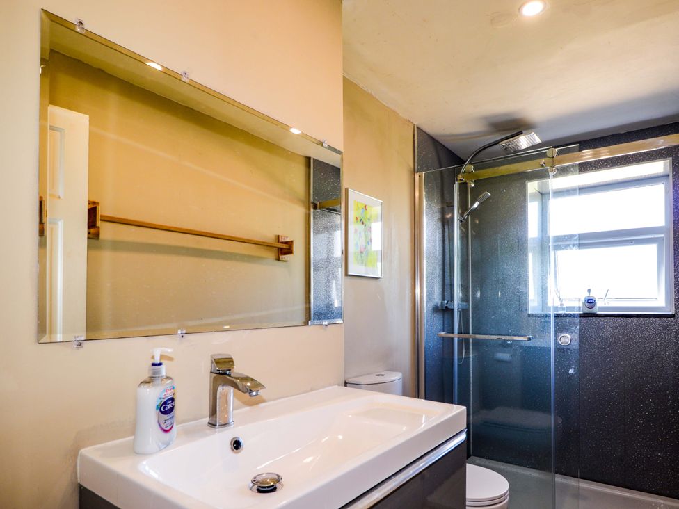 A bathroom featuring a sink, shower, mirror, and toilet at 6 Hill Street