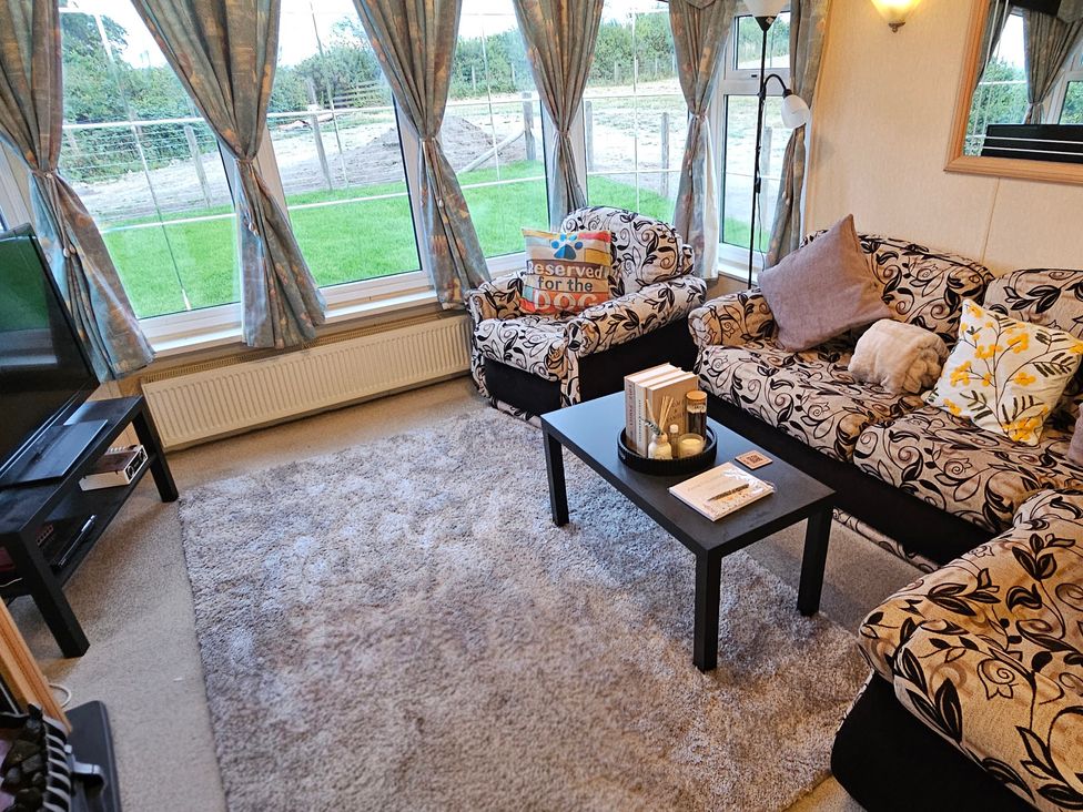 A living room with a sofa and coffee table at Balwen in Nercwys near Mold