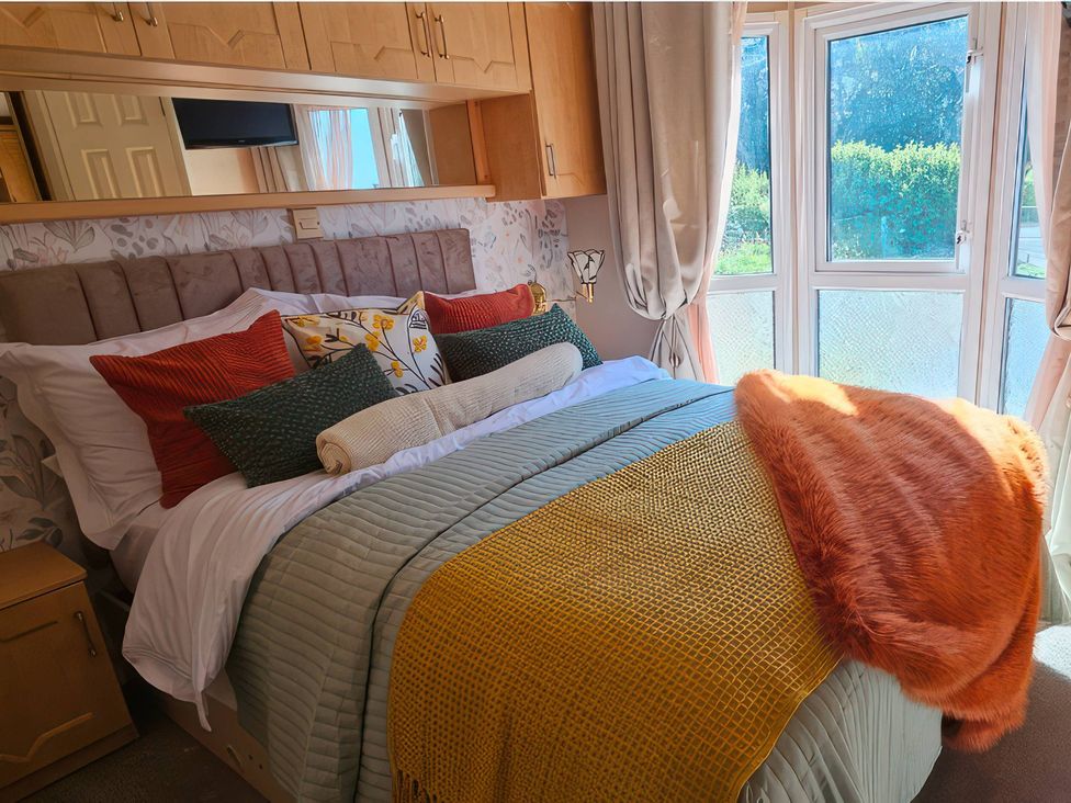 A bedroom with a bed and pillows at Balwen in Nercwys near Mold