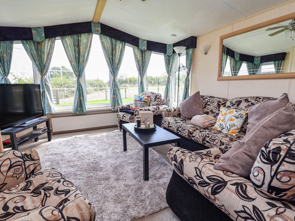 A snug with sofas and a coffee table at Balwen in Nercwys near Mold
