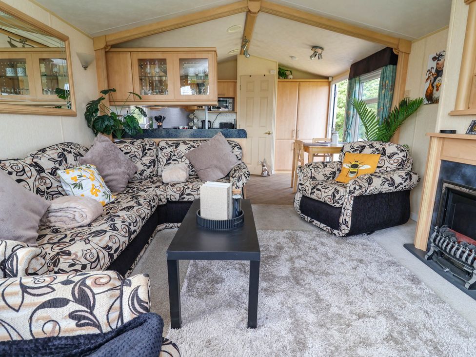 A living room with sofa and armchair at Balwen in Nercwys near Mold