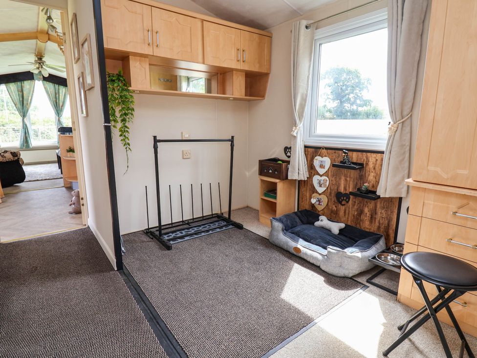 A living room with a dog bed and shoe rack at Balwen in Nercwys near Mold