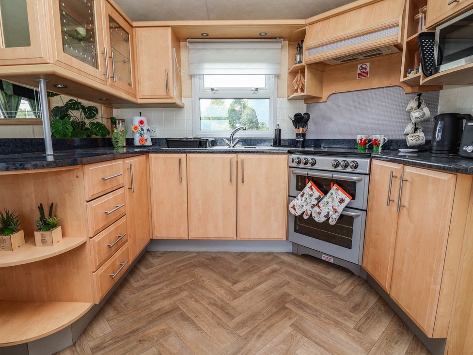 A kitchen with sink and oven at Balwen Nercwys near Mold