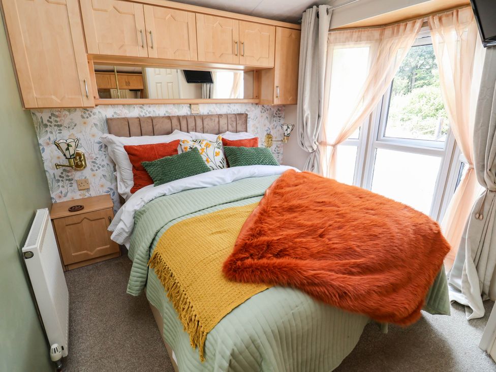 A bedroom with a bed and a window at Balwen in Nercwys near Mold