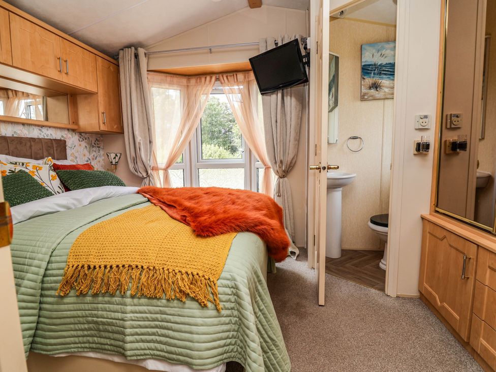 A bedroom with a bed and television at Balwen in Nercwys near Mold