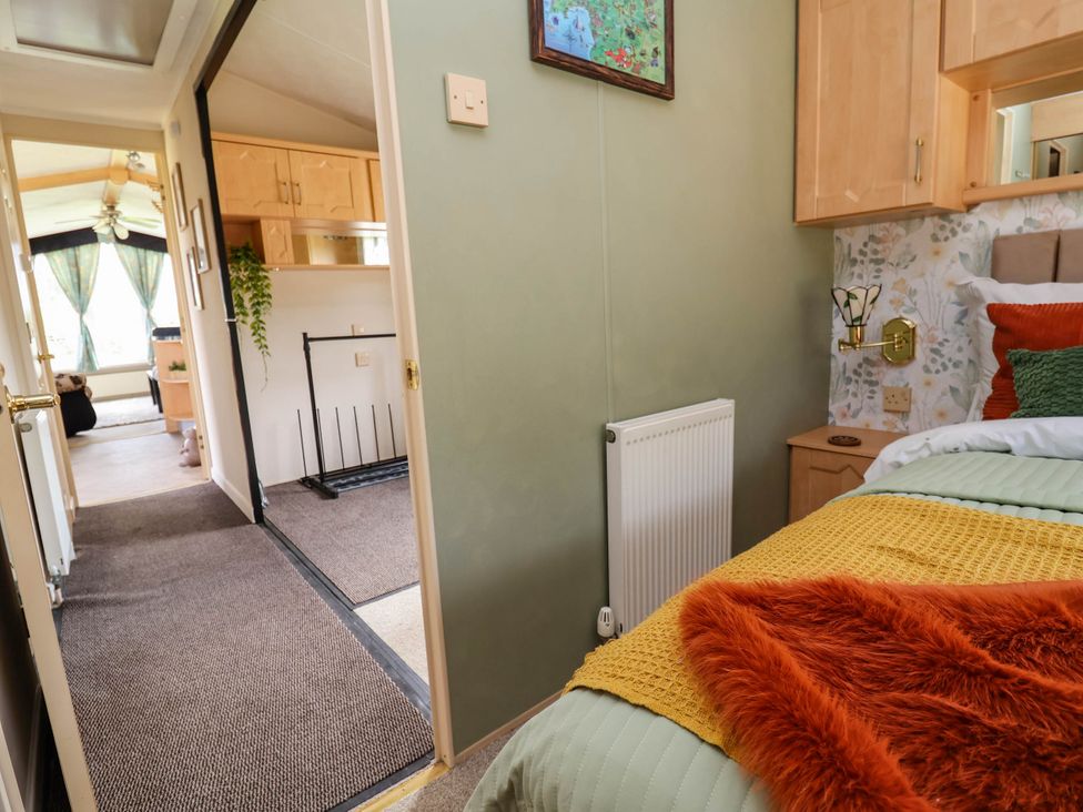 A bedroom with a bed and a view of the hallway at Balwen in Nercwys near Mold