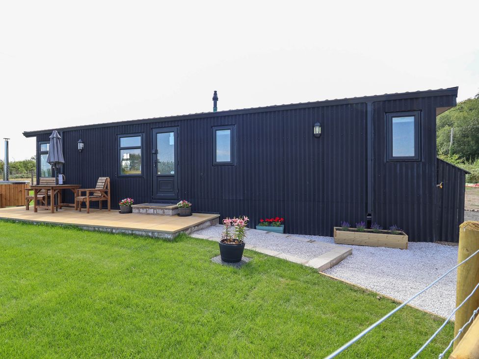 A container cabin with a deck and seating area at Balwen in Nercwys near Mold