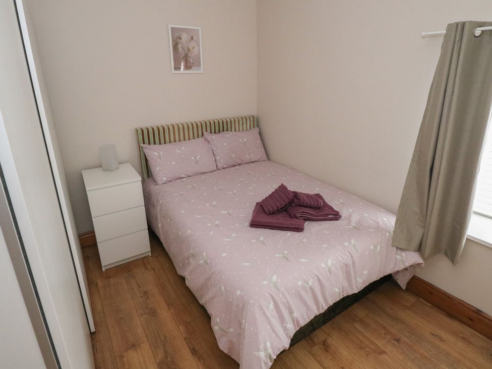 A bedroom with a double bed and a nightstand at Ti Maolla in Hollymount