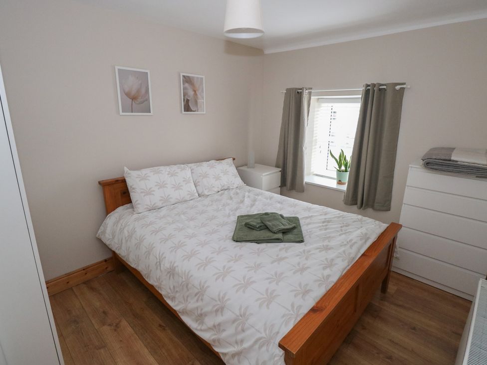 A bedroom with a bed and dresser at Ti Maolla in Hollymount