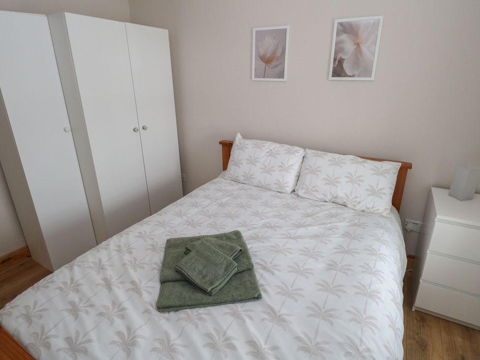 A bedroom with a bed and wardrobe at Ti Maolla in Hollymount