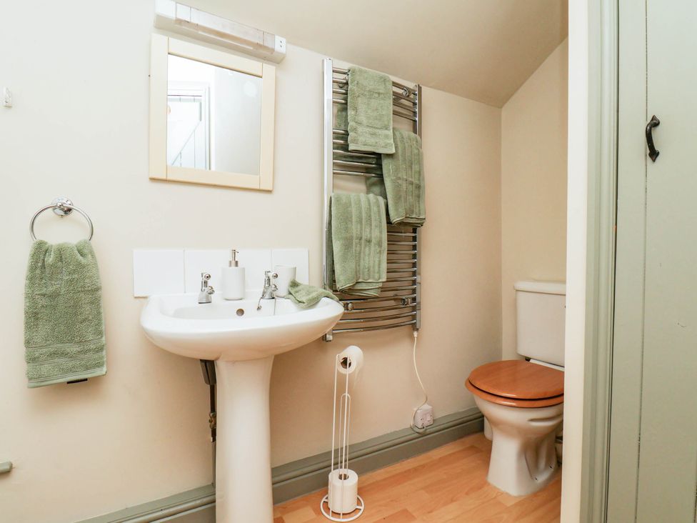 A bathroom with a sink and toilet at The Snug Glaisdale