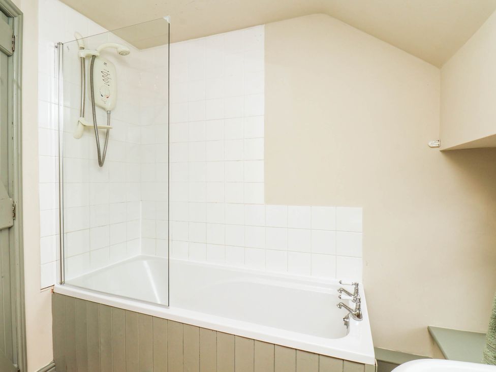 A bathroom with a bathtub and shower at The Snug Glaisdale