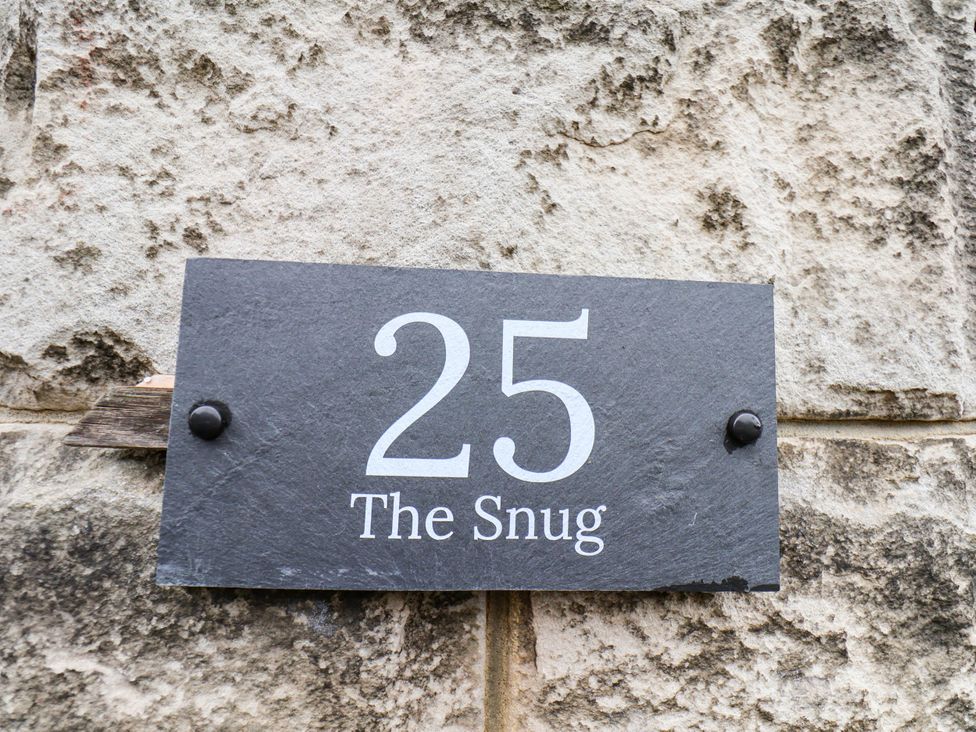 A sign displaying number 25 and the name The Snug
