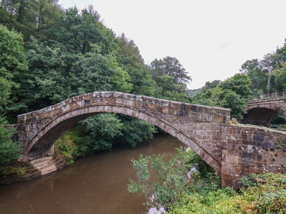 A bridge over a river with trees surrounding at The Snug Glaisdale Glaisdale