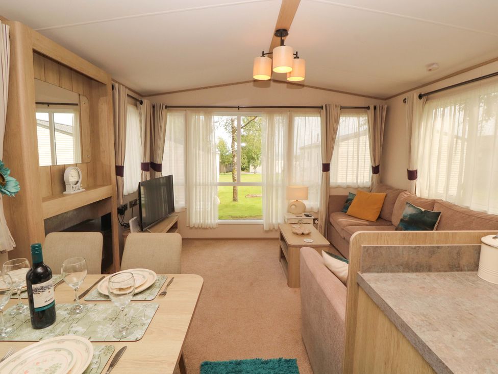 A living room with a sofa and television at Caravan
