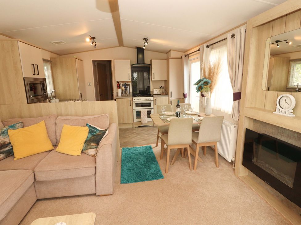 A living room with a sofa and dining area at Caravan