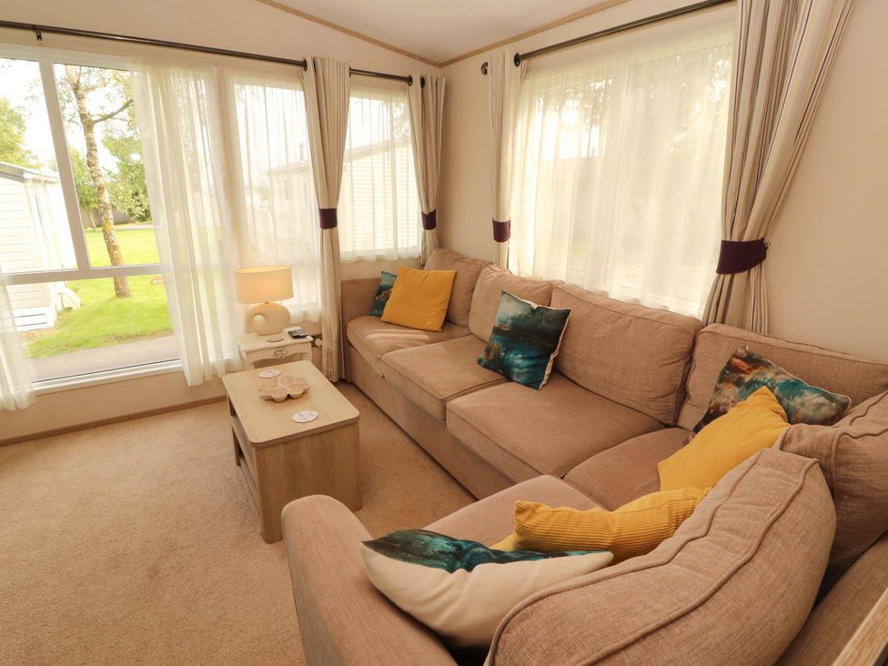 A living room with a sofa and coffee table at Caravan