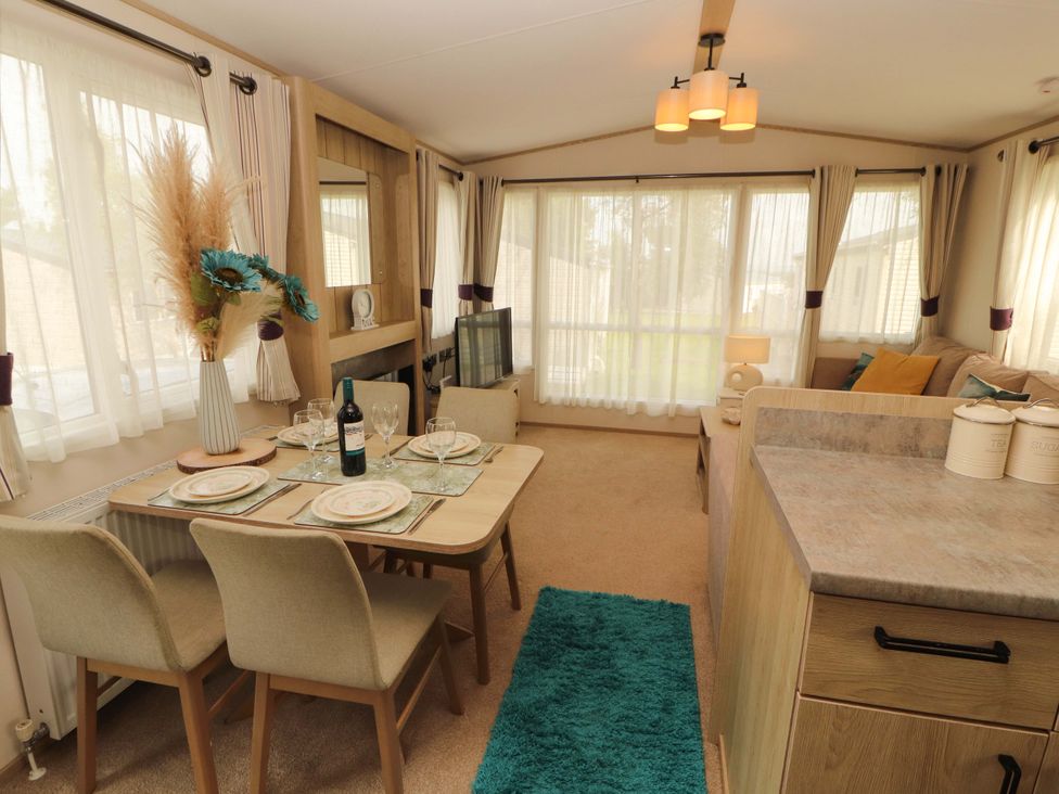 A dining area with a table and chairs at Caravan