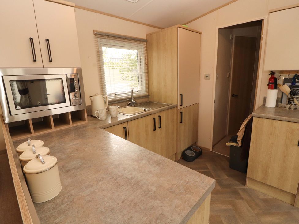 A kitchen with a microwave and sink at Caravan