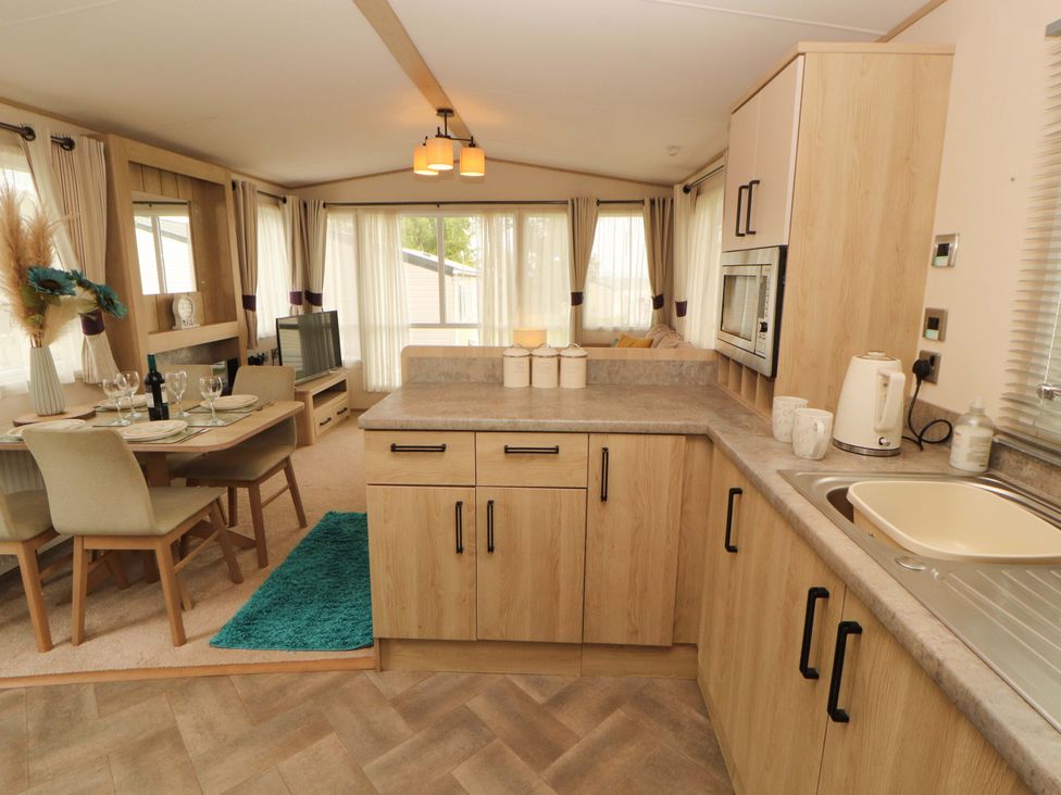 A kitchen with dining area and appliances at Caravan 