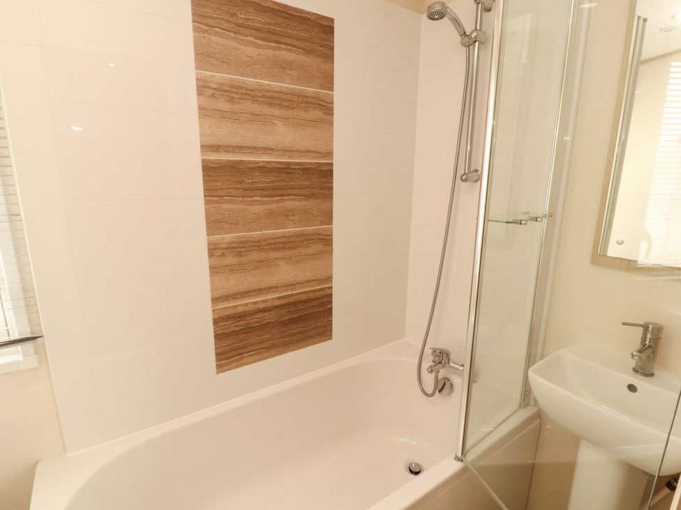 A bathroom with a bathtub and a shower at Caravan