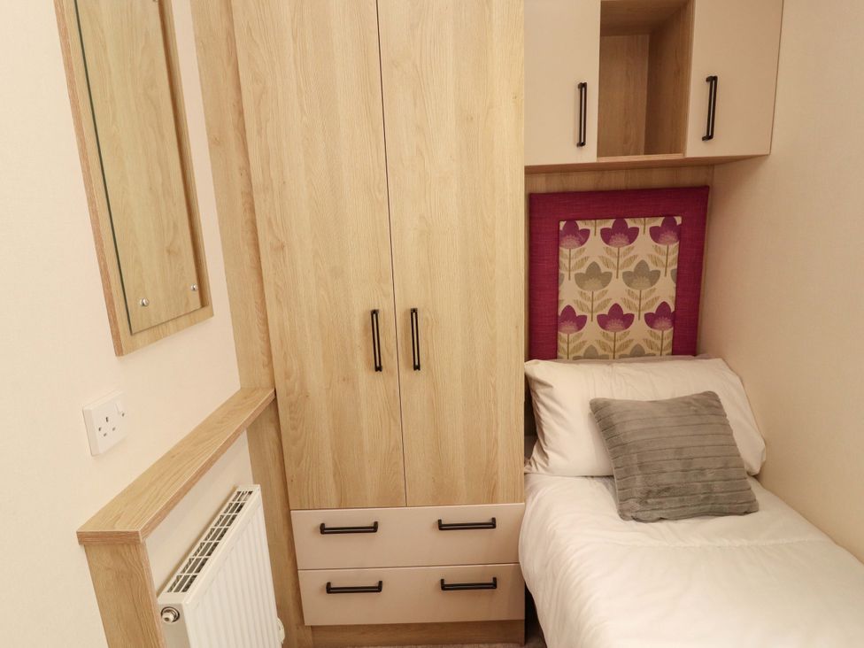 A bedroom with a bed and wardrobe at Caravan in 