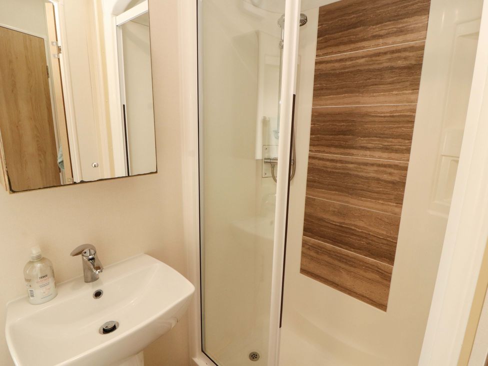 A bathroom with a shower and sink at Caravan in 