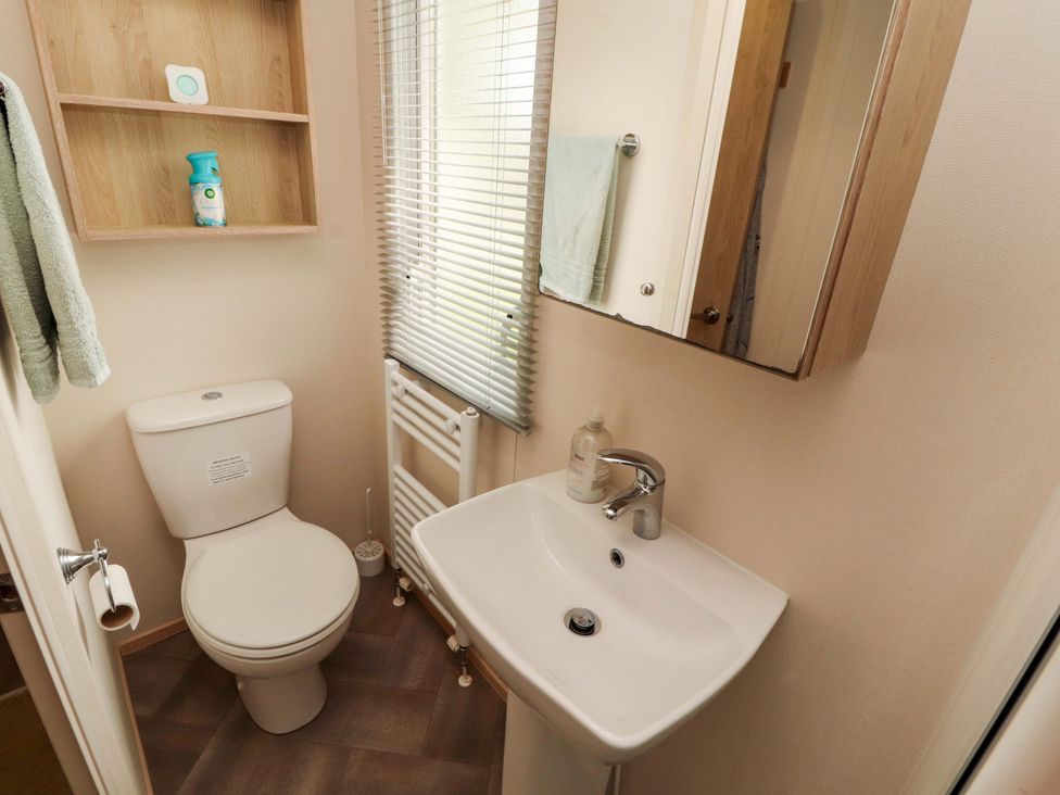 A bathroom with a toilet and sink at Caravan