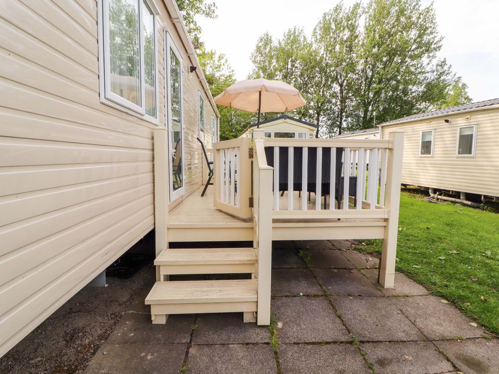 A deck with steps and an umbrella at Caravan