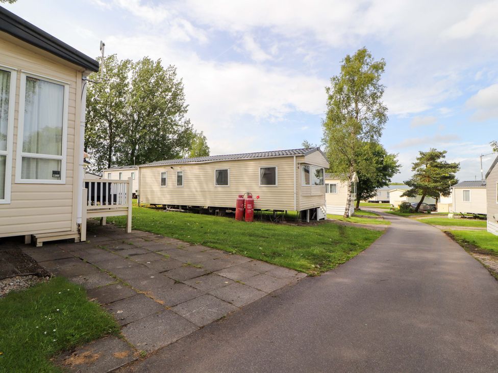 A caravan park with caravans and gas cylinders at Caravan located 