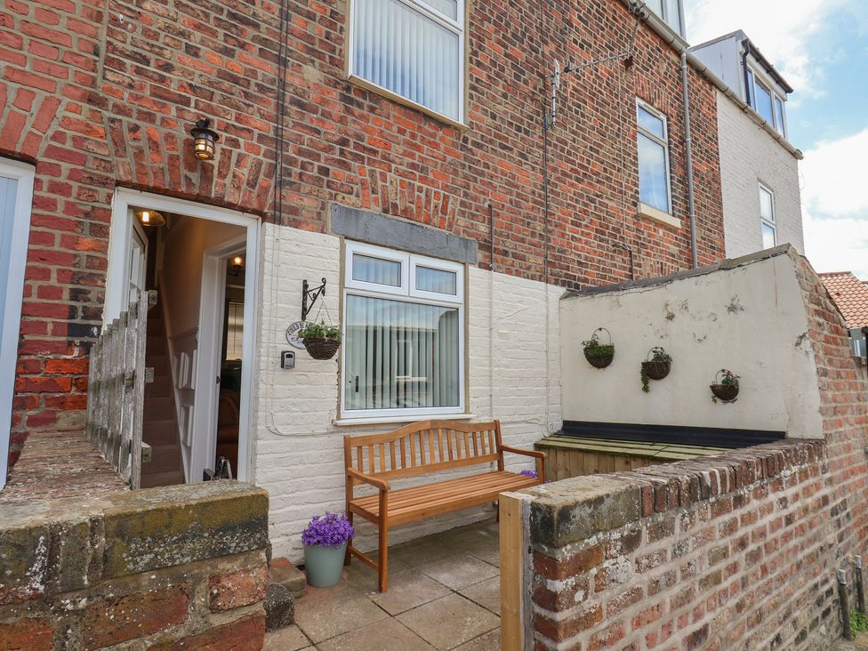 A bench in front of a brick wall at 4 Studley Terrace Whitby