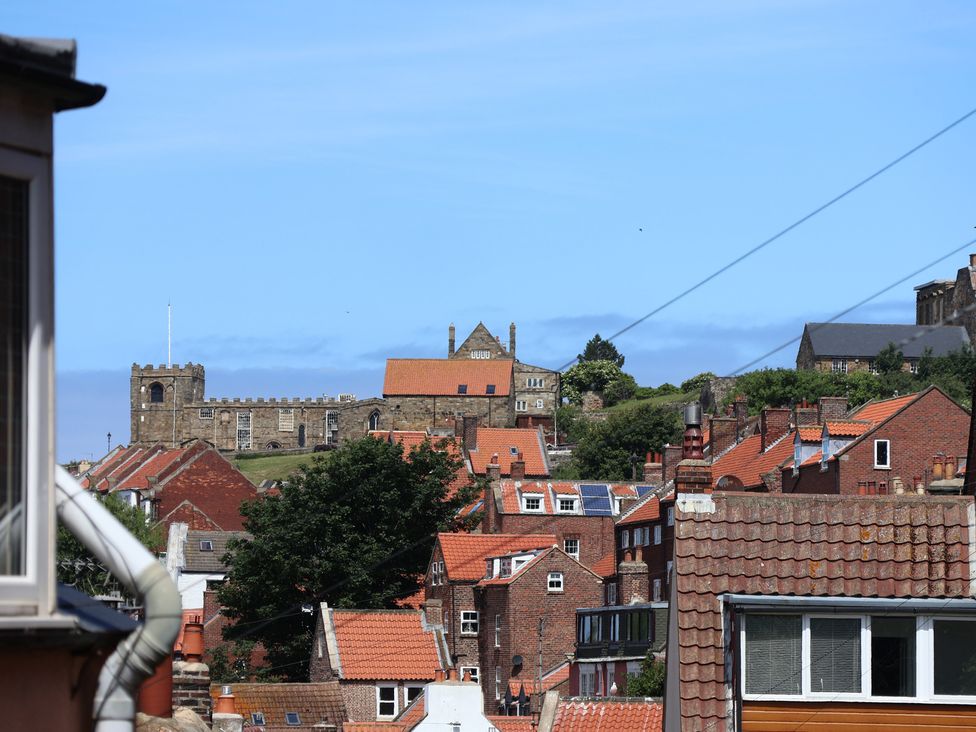 A view of rooftops and a church at 4 Studley Terrace Whitby