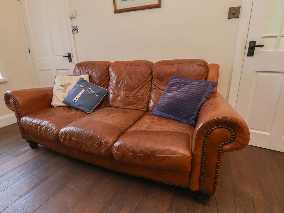 A sofa with pillows at 4 Studley Terrace Whitby