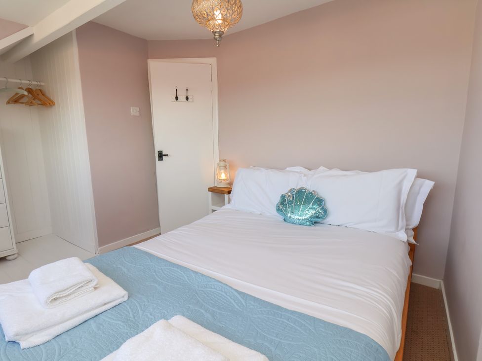 A bedroom with a bed and lantern at 4 Studley Terrace in Whitby