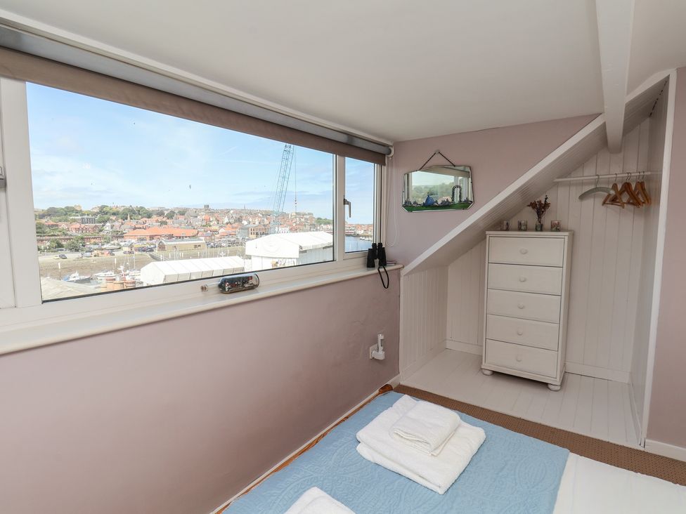 A bedroom with a window and dresser at 4 Studley Terrace in Whitby
