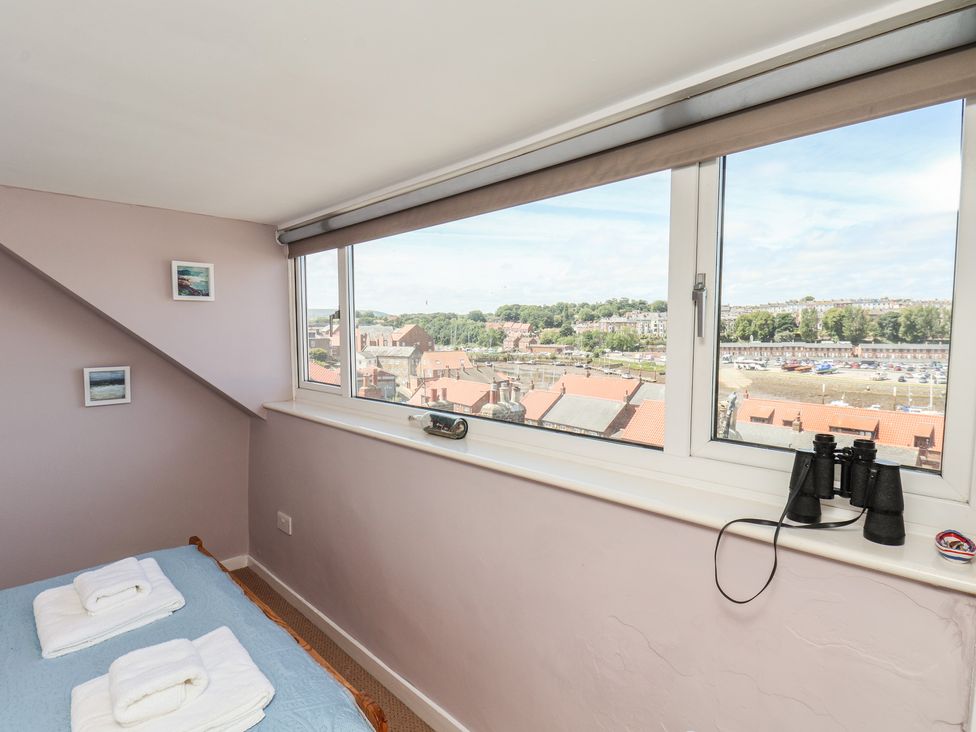 A bedroom with a bed and binoculars at 4 Studley Terrace in Whitby