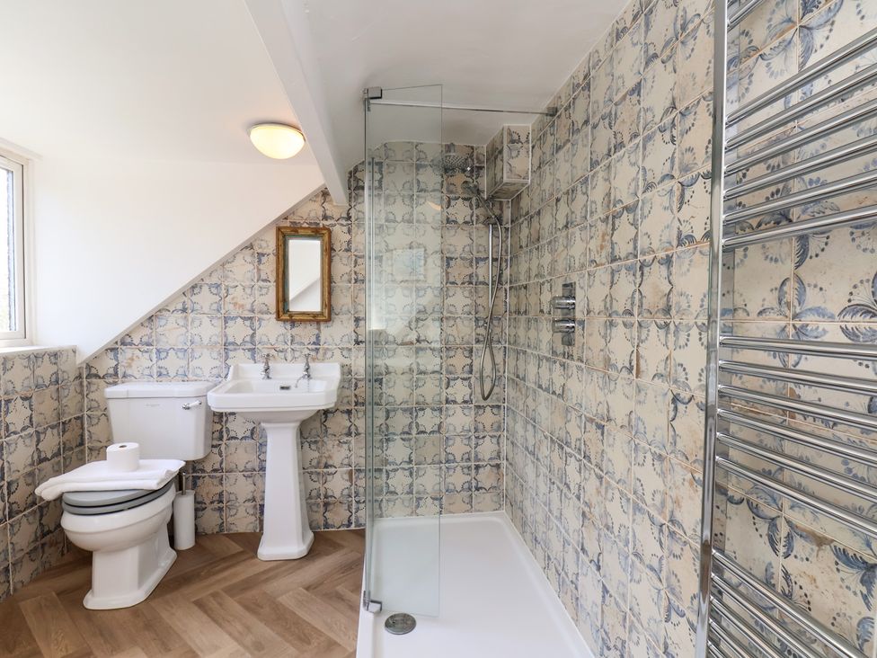 A bathroom with shower and sink at 4 Studley Terrace in Whitby
