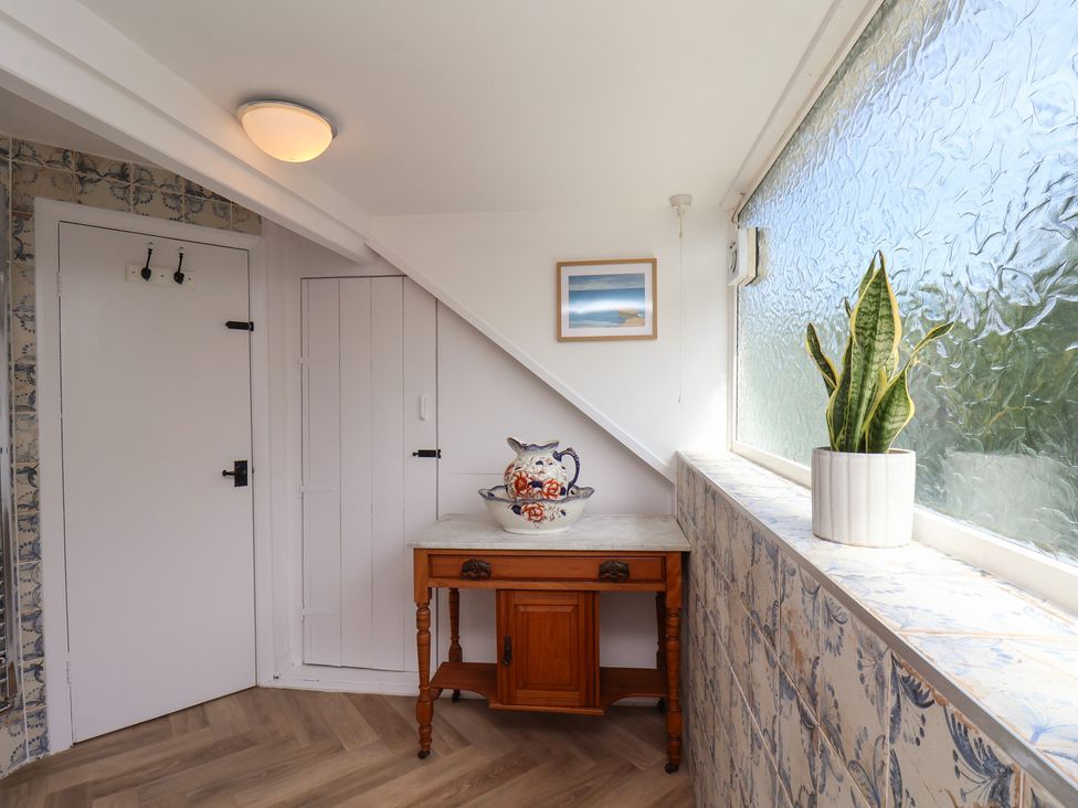 An entrance hall with a table and plant at 4 Studley Terrace in Whitby