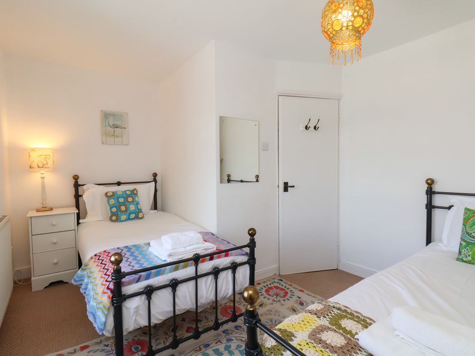 A bedroom with two single beds and a dresser at 4 Studley Terrace Whitby