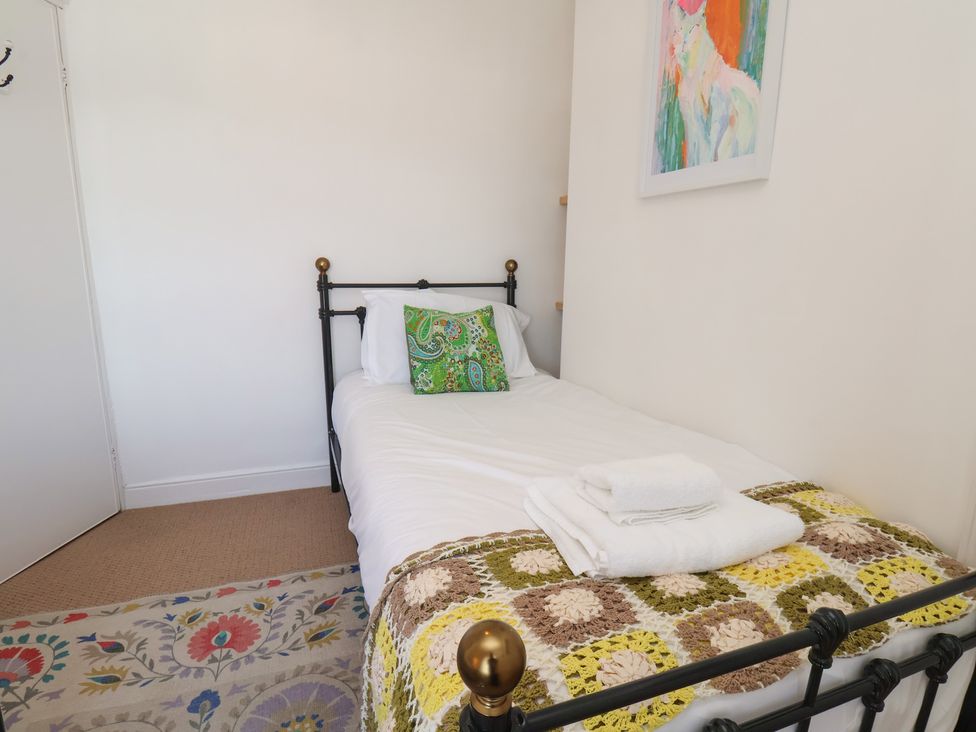 A bedroom with a single bed and decorative items at 4 Studley Terrace Whitby