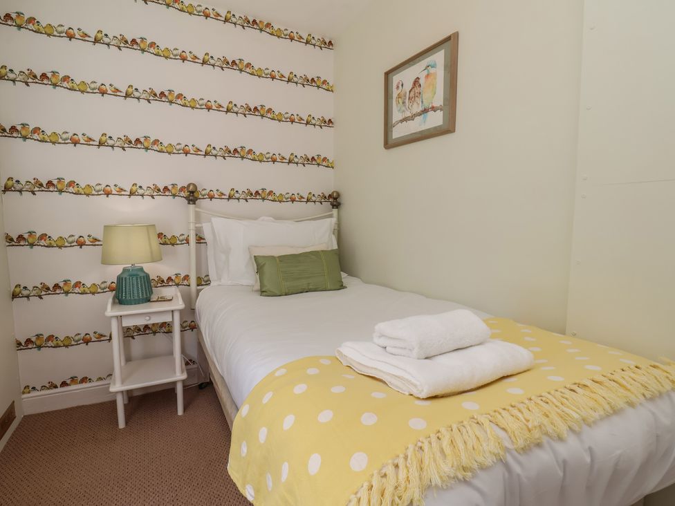 A bedroom with a bed and lamp at 4 Studley Terrace in Whitby