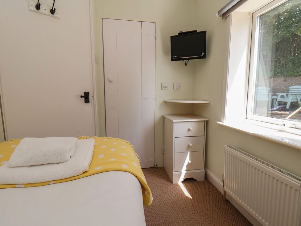 A bedroom with a bed and a television at 4 Studley Terrace in Whitby