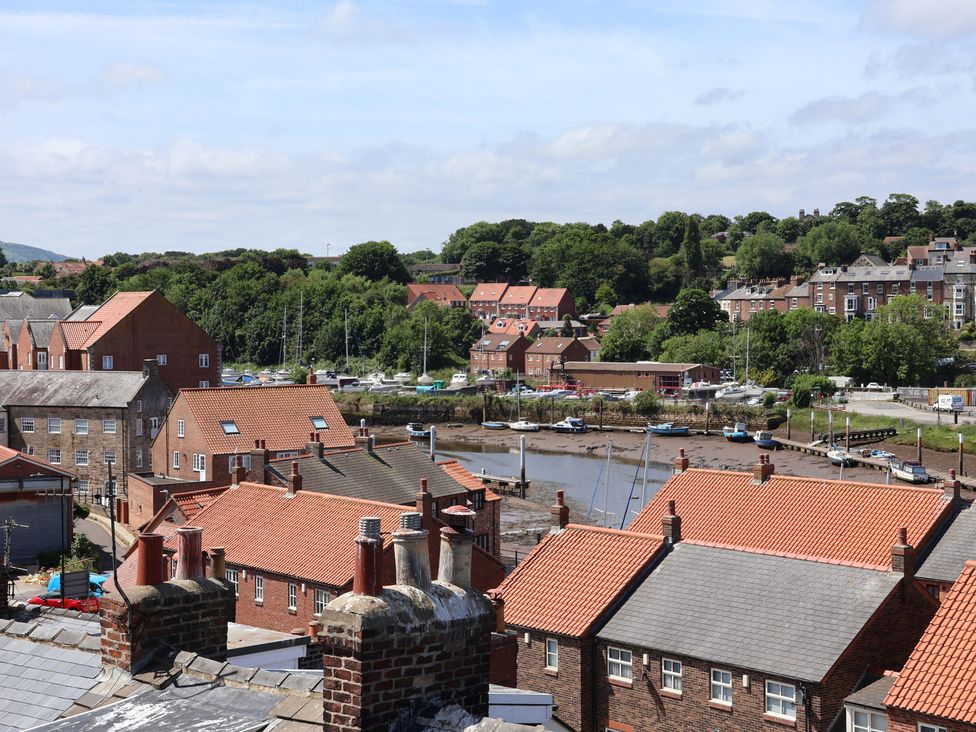 A view of houses and boats by the water at 4 Studley Terrace in Whitby