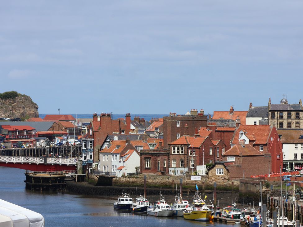 A view of boats and houses at the harbor at 4 Studley Terrace in Whitby
