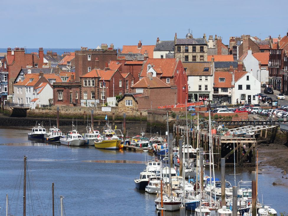 A view of boats and buildings in a harbor at 4 Studley Terrace in Whitby