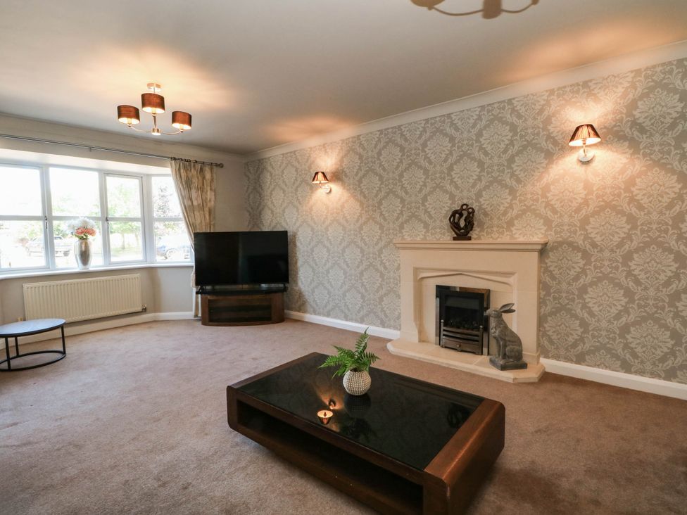 A living room with a television and a fireplace at The Ferns in Kirkham