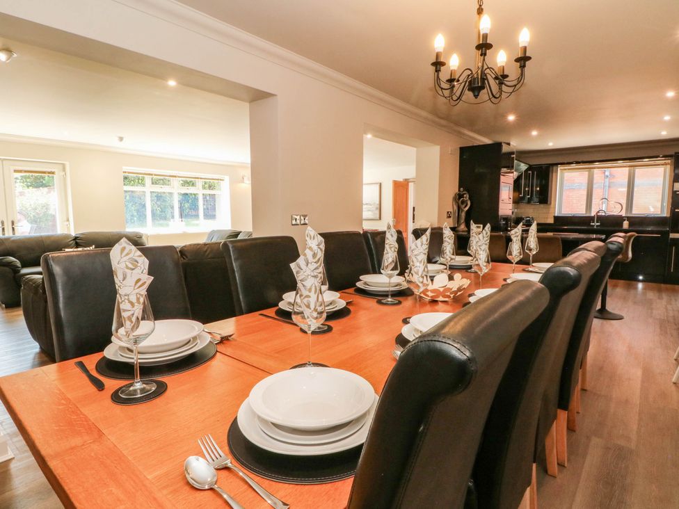 A dining room with a large table set with tableware and cutlery at The Ferns in Kirkham